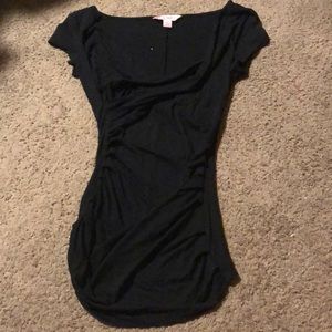 Black shirt, rutched sides, scoop neck.